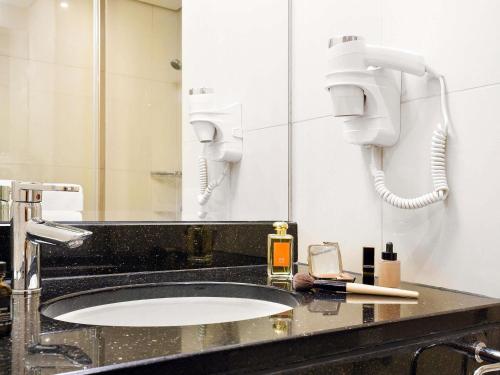 a bathroom with a sink and a mirror at ibis Dubai Al Rigga in Dubai