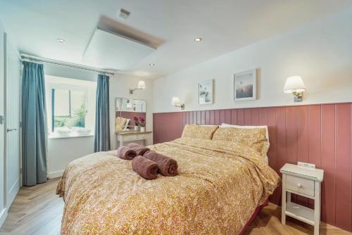 a teddy bear laying on a bed in a bedroom at 1 Bed in Stewarton oc-c44699 in Stewarton