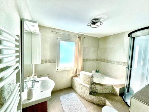 a bathroom with a tub and a sink and a bath tub at Auszeit im Grünen in Gailitz