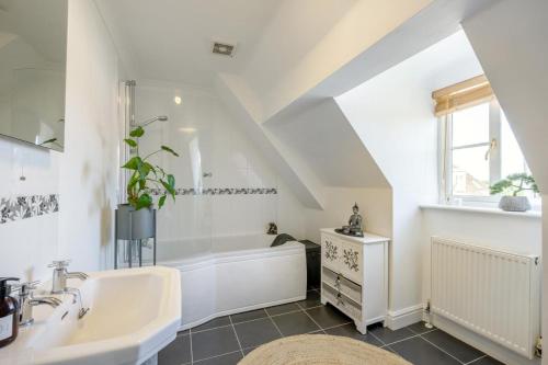 a bathroom with a white tub and a sink at 2 Bed in Blythburgh oc-w42765 in Blyford
