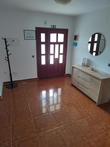 a room with a door and a table and a mirror at Manuela in Ližnjan
