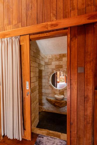 a bathroom with a sink and a mirror at Two Sisters Villa with Pool - Sire in Tanjung