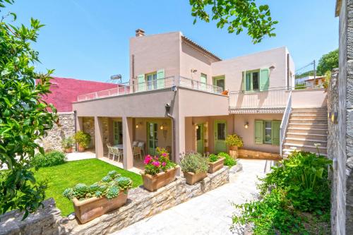 an exterior view of a house with plants at Villa Verde Petra in Rethymno