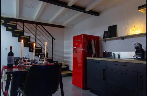 a kitchen with a red refrigerator and a table at Ruelle Sensuelle in Ruelle-sur-Touvre