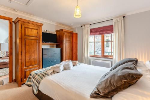 a bedroom with a large white bed and a window at 2 Bed in St. Fillans oc-a40242 in Saint Fillans