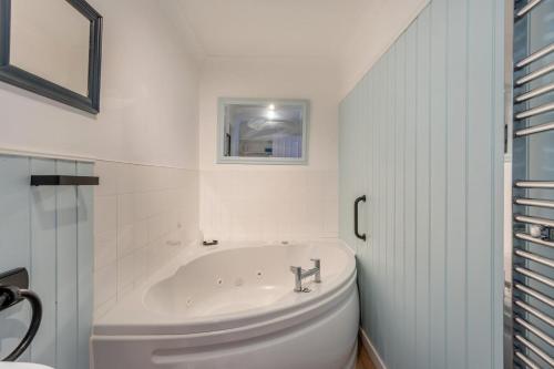 a white bathroom with a tub and a toilet at 2 Bed in St. Fillans oc-a40242 in Saint Fillans