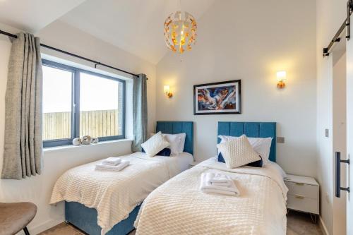 two beds in a room with a window at 2 Bed in Sennen oc-k35172 in Sennen