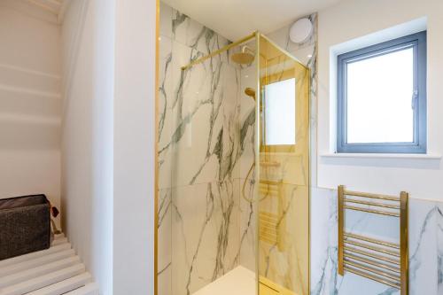 a shower with a glass door in a bathroom at 2 Bed in Sennen oc-k35172 in Sennen
