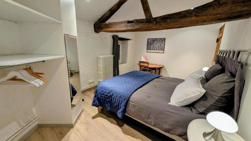 a bedroom with a large bed in a room at Patissou in Solignac