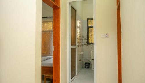 an open door to a bathroom with a bed in it at Eva Residence Arusha in Arusha