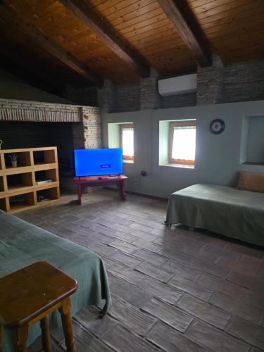 a room with two beds and a flat screen tv at Villa Mugs in Tirana