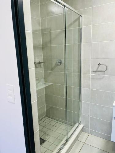 a shower with a glass door in a bathroom at Cozy&Pristine The Blyde in Pretoria