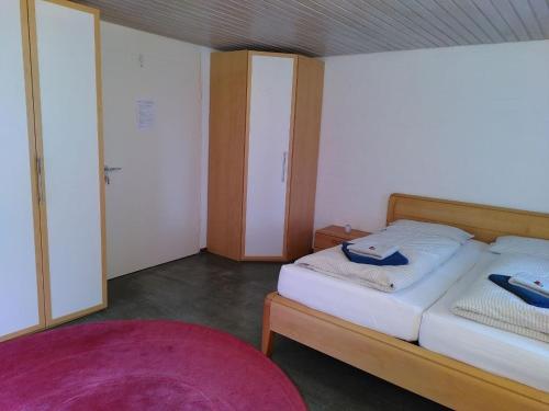 a bedroom with a bed with two blue slippers on it at Gästewohnung am Sternberg in Gomadingen