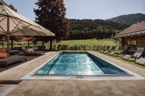 a swimming pool in the backyard of a house at Hotel loj - our kind of place in Flachau