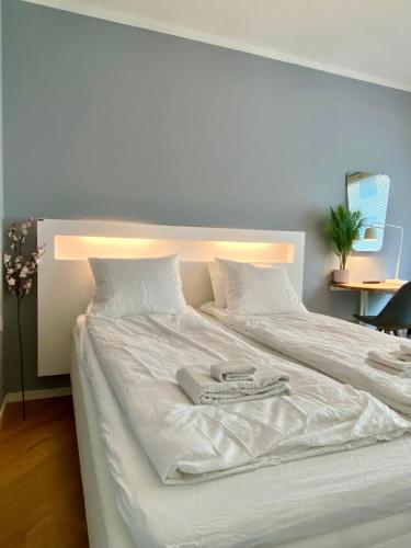 a large white bed with two towels on it at Studio Tokoi in Helsinki