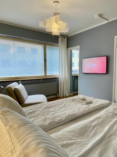 a bedroom with a bed and a flat screen tv at Studio Tokoi in Helsinki