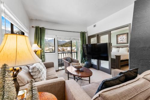 a living room with a couch and a television at Greens at Copper #314 in Copper Mountain