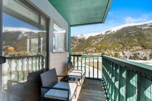 a balcony with two chairs and a view of mountains at Greens at Copper #314 in Copper Mountain