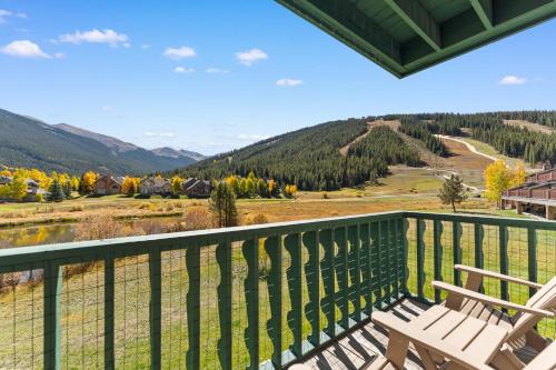 a balcony with two chairs and a view of the mountains at Greens at Copper #217 in Copper Mountain
