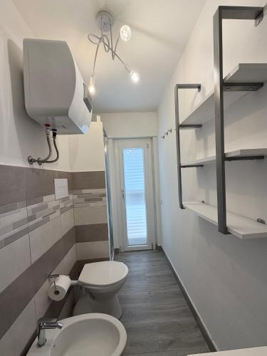 a bathroom with a toilet and a sink at Urban House in Nuoro