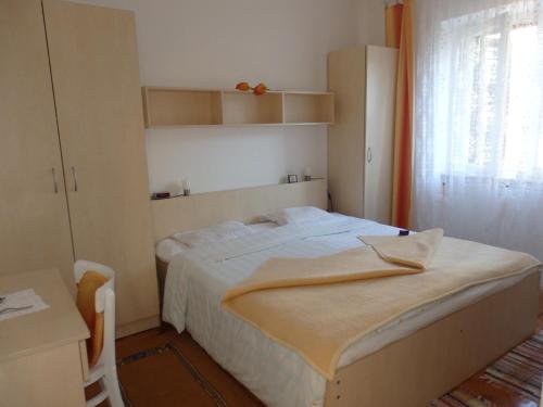 a small bedroom with a bed and a window at Slavica Bunić, Apartments in Supetarska Draga