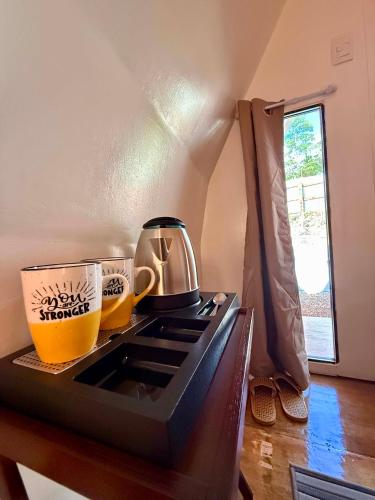 a kitchen with a stove with two cups on it at Payag ni Peping in Tacloban