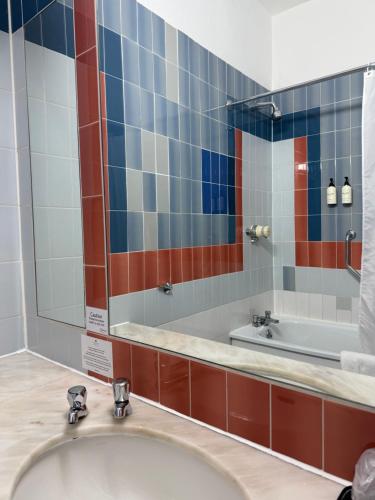 ein Badezimmer mit Badewanne und großem Spiegel in der Unterkunft Copthorne Hotel Manchester Salford Quays in Manchester