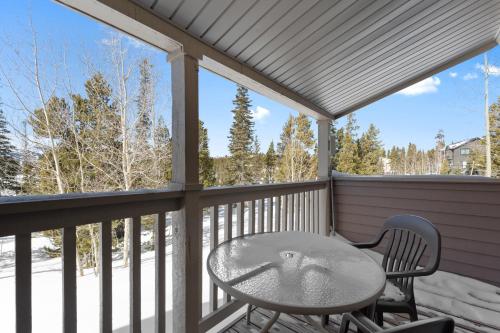 a table and chairs on a balcony with a view at Rockridge #41 in Breckenridge