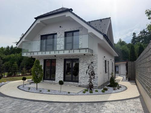 a white house with a lot of windows at Villa White Stone in Starý Smokovec