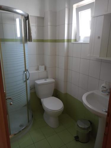 a bathroom with a toilet and a sink at EFFIE'S VACATION by the sea in Kanali