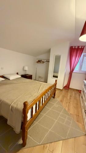 a bedroom with a large bed in a room at Vicko villa in Seget Vranjica
