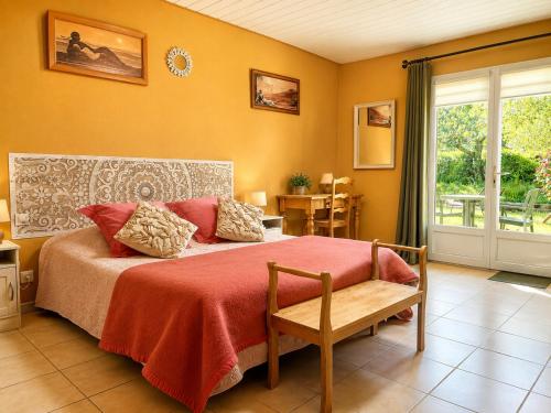 a bedroom with a large bed with a red blanket at Oasis Des Corbières in Boutenac