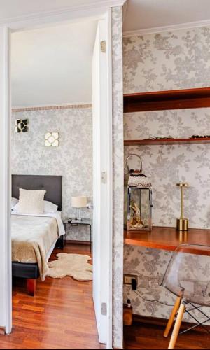 a bedroom with a bed and a wall with wallpaper at Lupe&Lulu aparments in Santiago