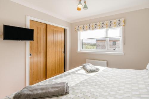 a bedroom with a bed and a flat screen tv at 2 Bed in Ochiltree oc-w37516 in Ochiltree