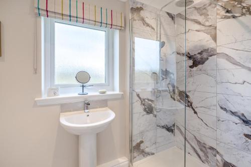 a bathroom with a toilet and a window and a sink at 2 Bed in Ochiltree oc-w37516 in Ochiltree