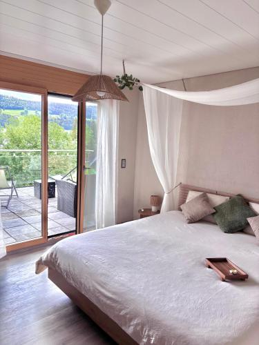 a bedroom with a bed with a tray on it at Lake View Balcony in Le Chenit