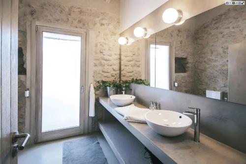 a bathroom with two sinks and a large mirror at Can Soto in Palma de Mallorca