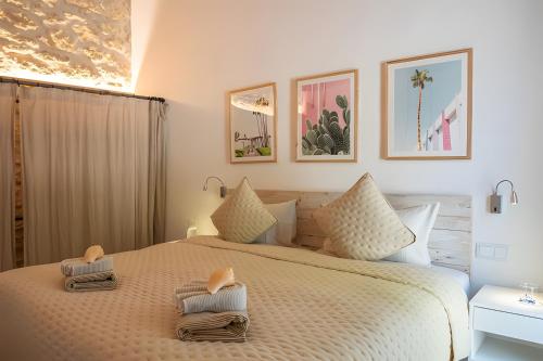 a bedroom with a large bed with towels on it at Can Soto in Palma de Mallorca