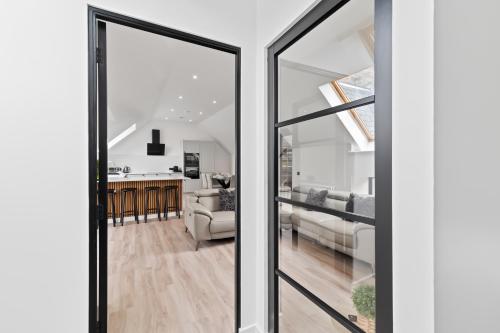 a view of a living room and kitchen from a glass door at Corn Flour Lodge - Pitkerro Mill in Dundee