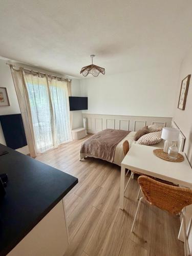 a bedroom with a bed and a desk and a table at Numéro 6 in Toulouse