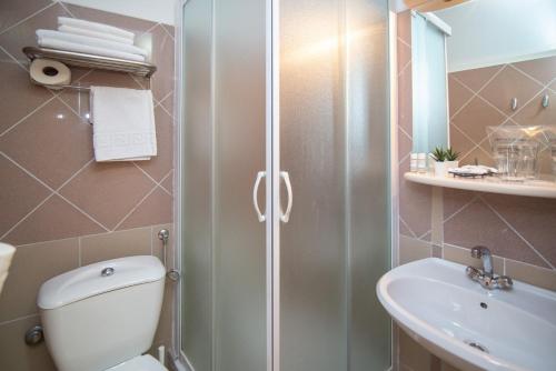 a bathroom with a shower and a toilet and a sink at Bed&Breakfast Saturn in Veli Lošinj
