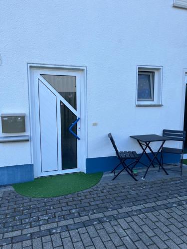 a door with a table next to a building at Anjas Ferienwohnung Buchenrod in Flieden