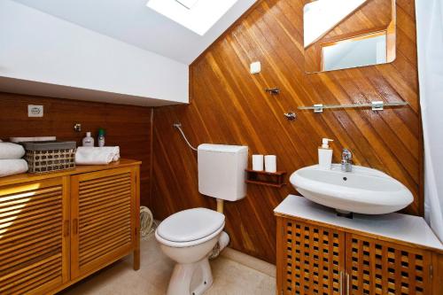 a bathroom with a toilet and a sink at Apartment Plaza in Hvar