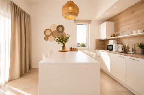 a kitchen with a white island in a room at Premium Residence Virotel in Vir