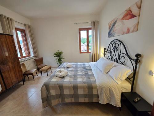 a bedroom with a bed and two chairs in it at B&B Il Tralcio in Cascia