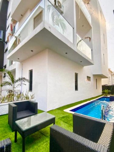 an image of a house with a swimming pool at Premium Height in Ikate