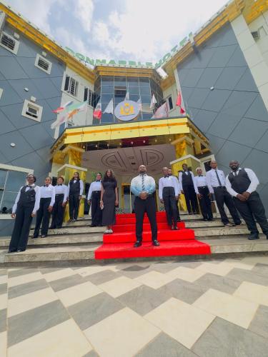 a group of people standing on a red carpet at Don Marble Hotel And Suites in Auchi