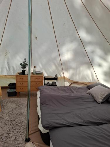 a bedroom with a bed in a tent at Glamping in Alingsås