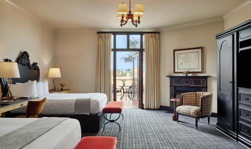 a hotel room with a bed and a desk and chair at French Quarter Inn in Charleston
