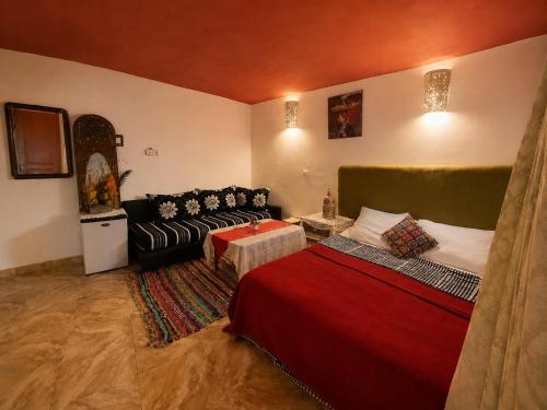 a living room with a bed and a couch at Dar Amine in Rabat